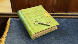 Lime green bound book with an ornate key