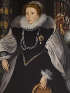 Elizabeth I in a black dress with white ruff and cuffs, and grey cloak holding a sieve, with courtiers visible just visible behind a heavy curtain and globe.