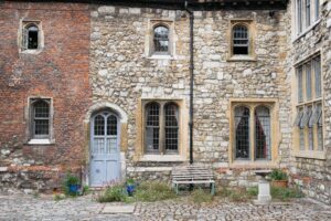 Exterior of a building which is red brick on the left and stone on the right