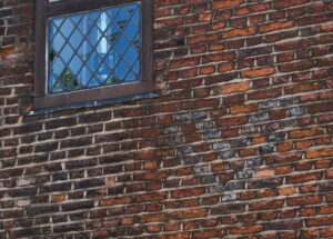Details of a heart in the brickwork in the external wall of Wash-House Court